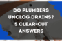 Do plumbers unclog drains? Plumber using hydro-jetting equipment to unclog a residential drain.